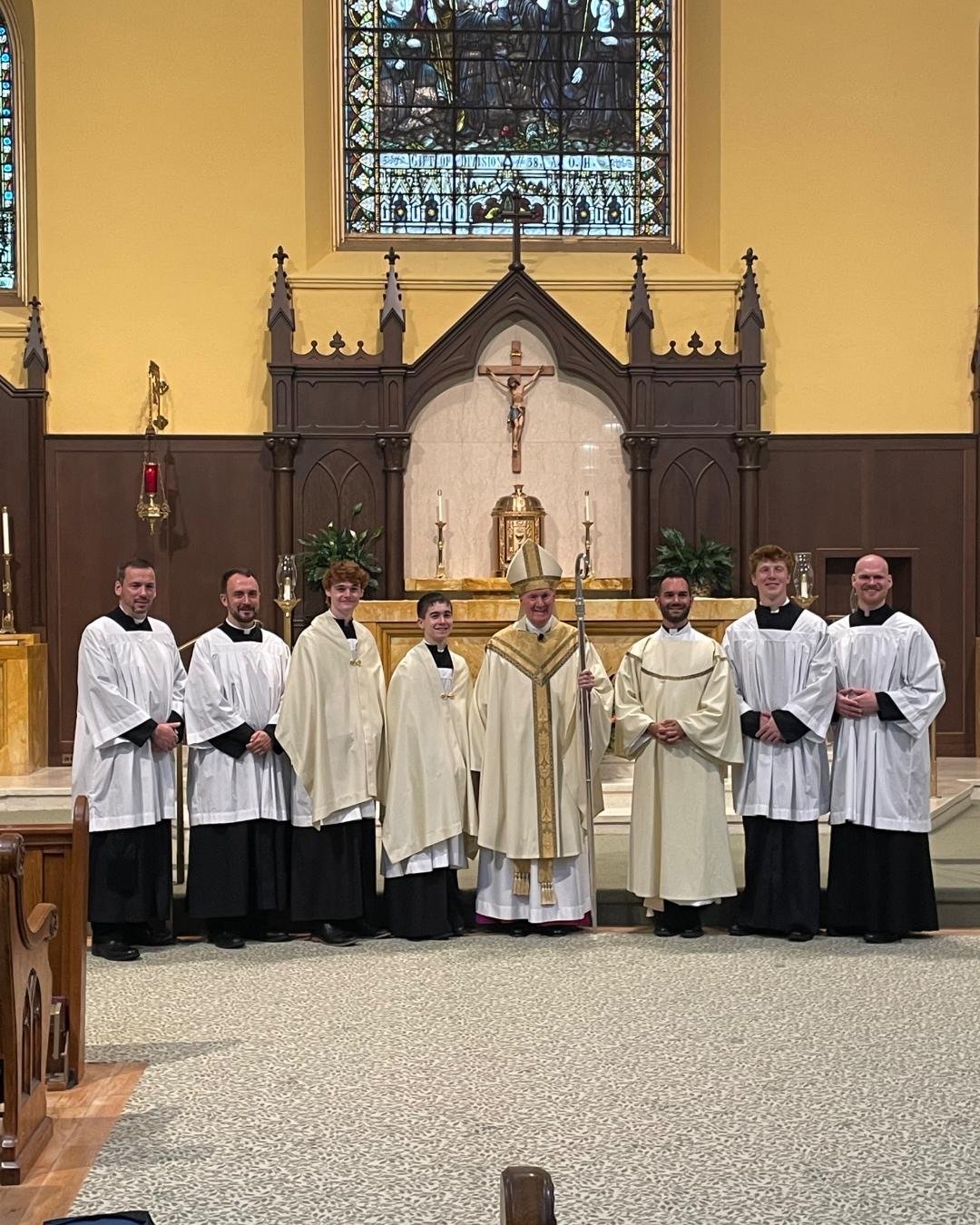 Clergy and Salesianum seniors at the altar after a diaconate ordination Mass
