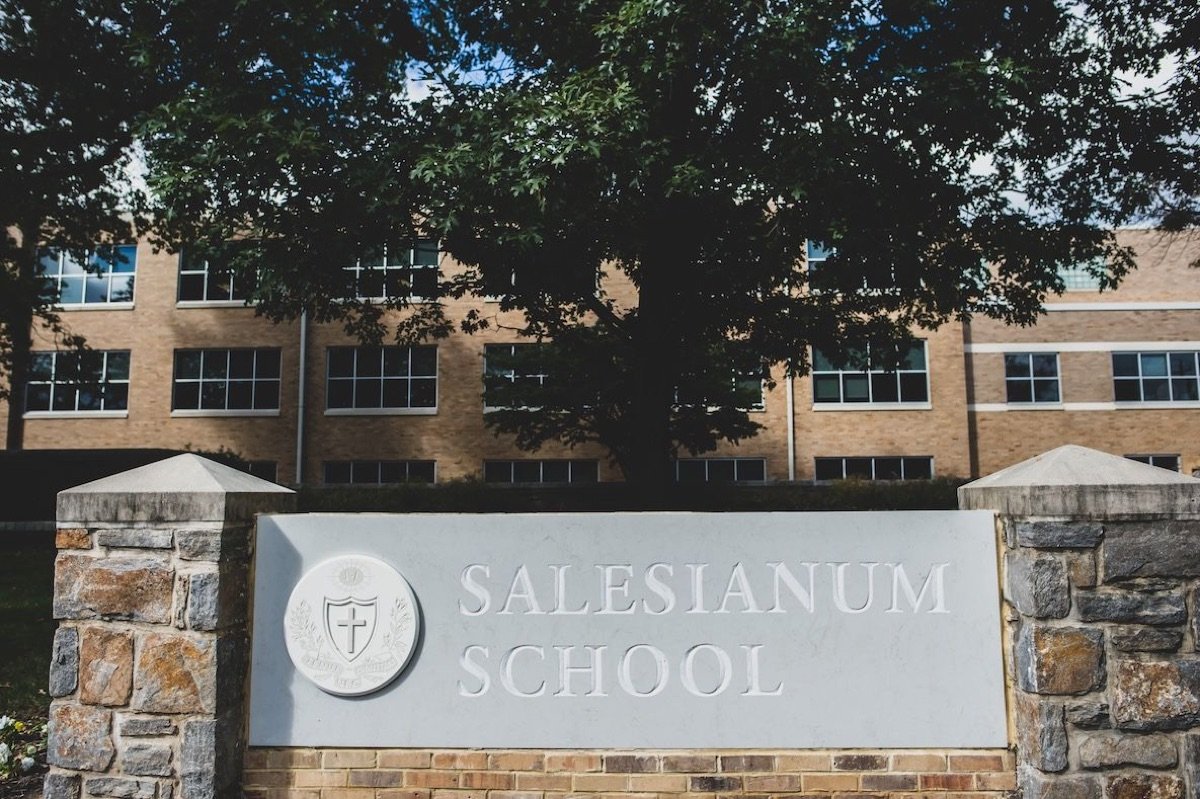 The Salesianum School sign on its stone base outside the Broom Street building
