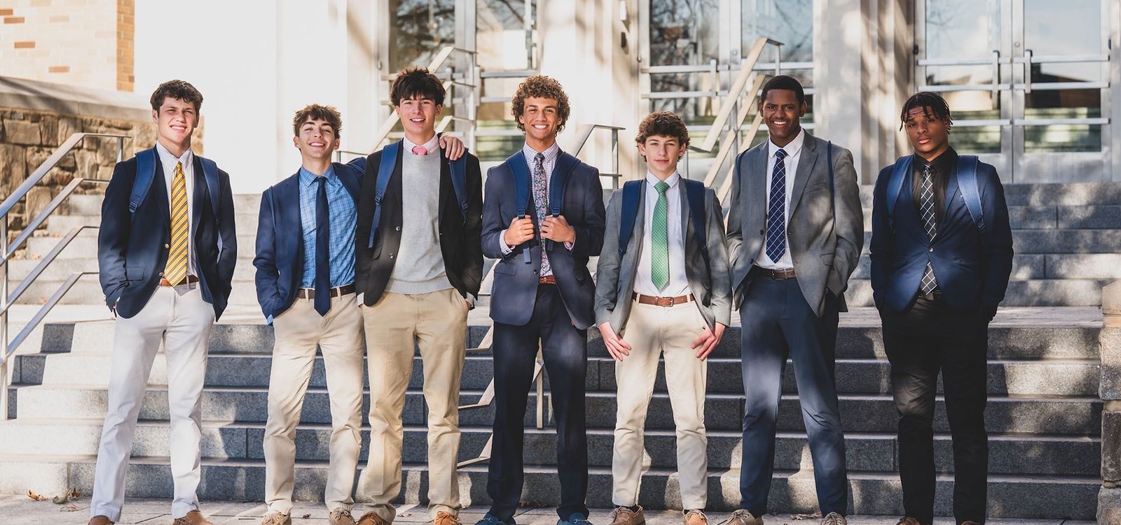 Salesianum students in blazers on the front steps of the school